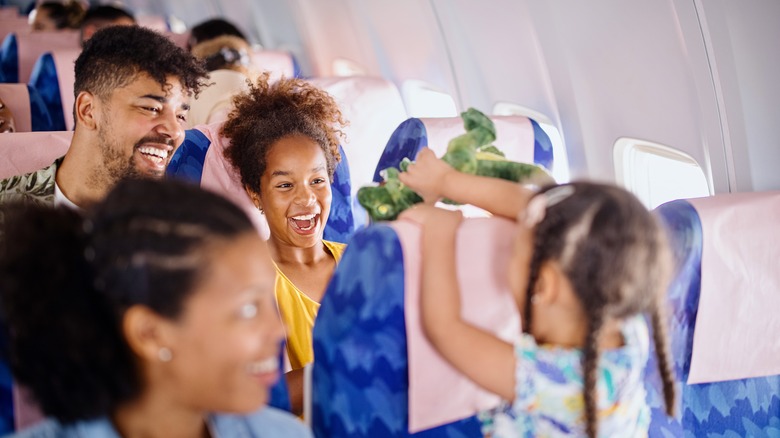 Family laughing on airplane