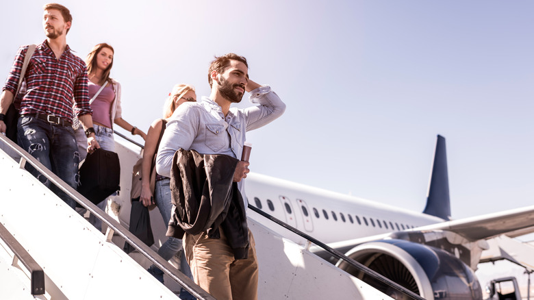 Travelers getting off plane