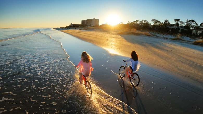 Kids riding bikes on beach 