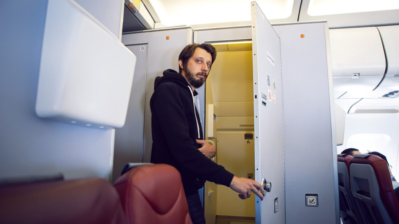 Man standing in lavatory doorway