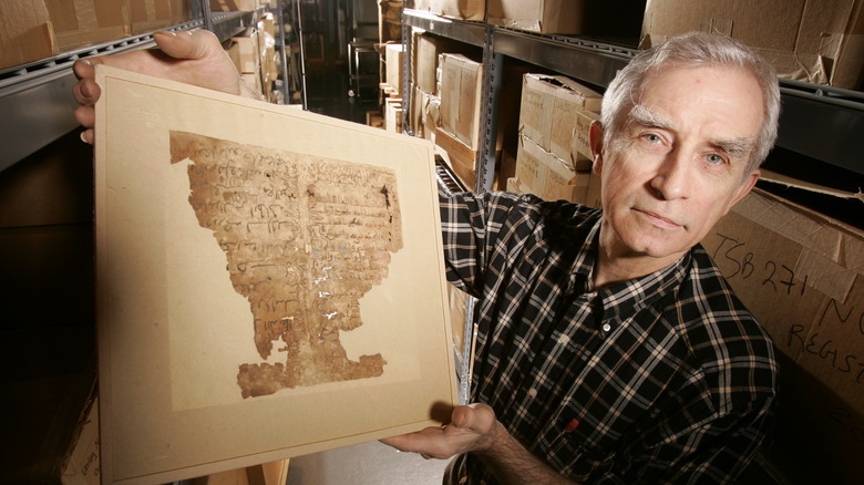 Man holding ancient manuscript