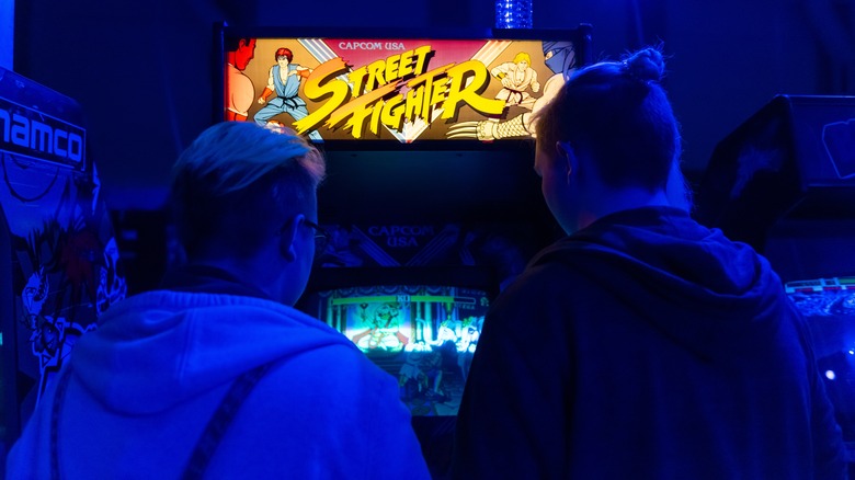 two people playing Street Fighter arcade