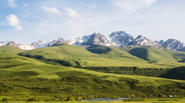 Green hills and snowy mountains