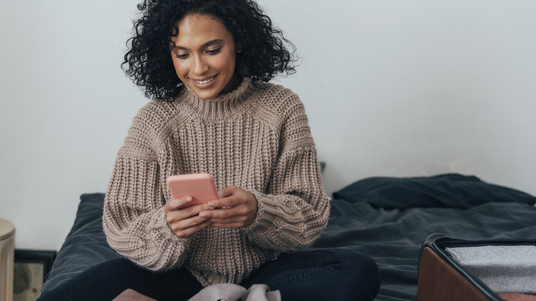 Traveler smiling at phone