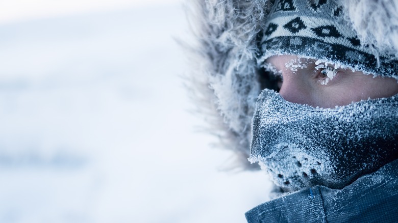 Man wears facemask in snow