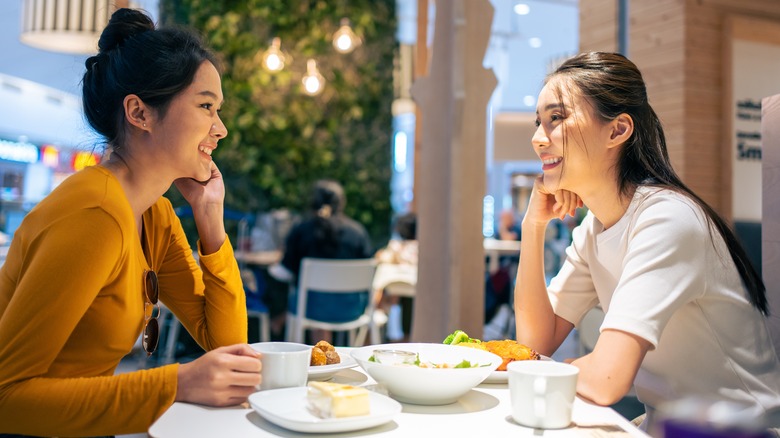 Smiling women dining in cafeteria