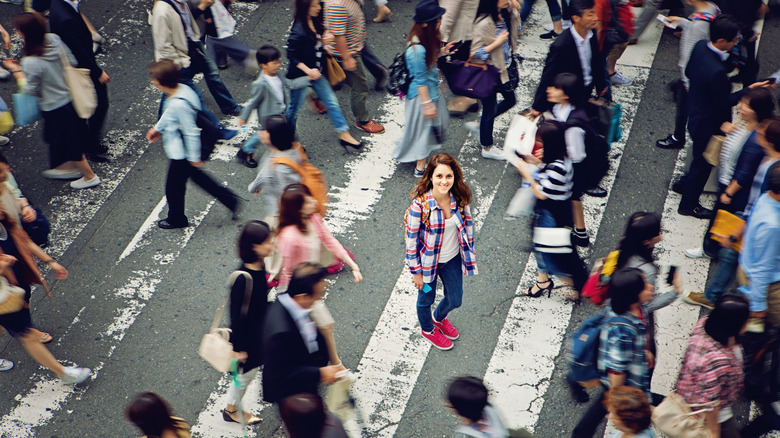 Smiling traveler in Tokyo crowd