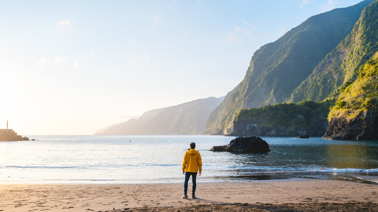 A man stands on the beach in Setúbal