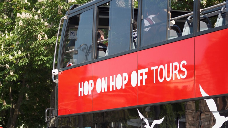 Hop On Hop Off Tours sign on side of bus