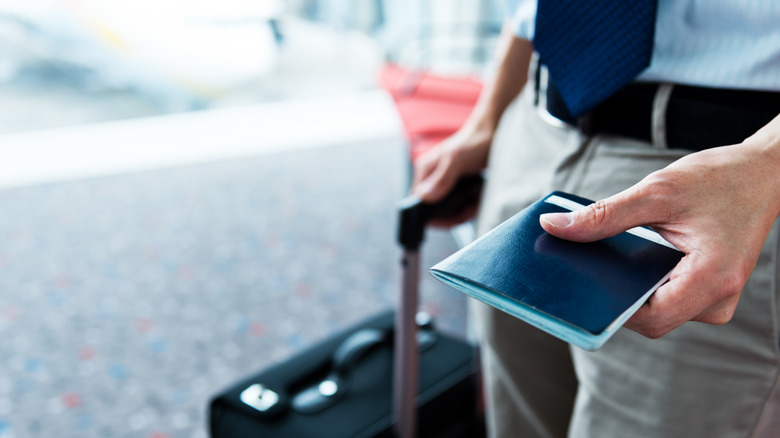 traveler holding passport