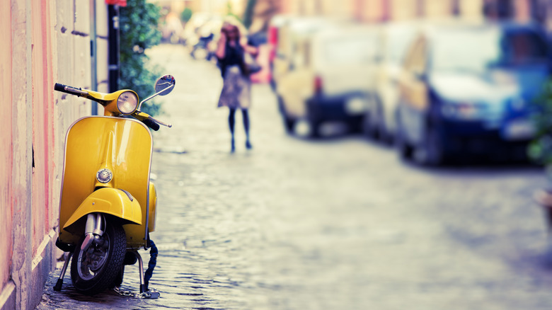 Yellow scooter parked on street