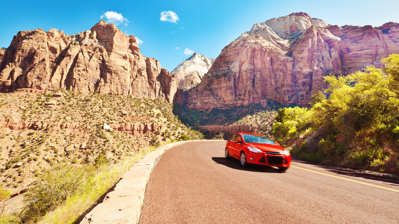 Car with canyons in background