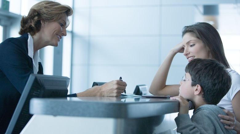 travelers and airport gate agent