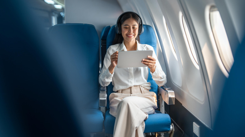 smiling woman on plane