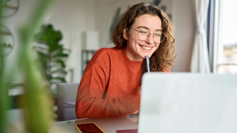young, smiling woman doing research