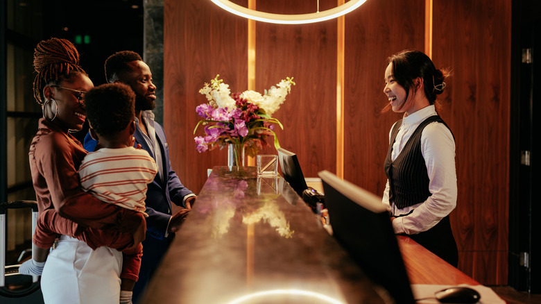 family checking into hotel