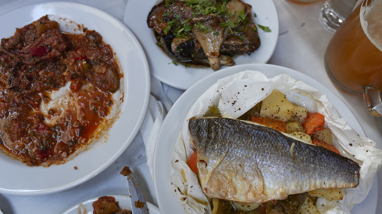 Traditional Greek dishes on white plates