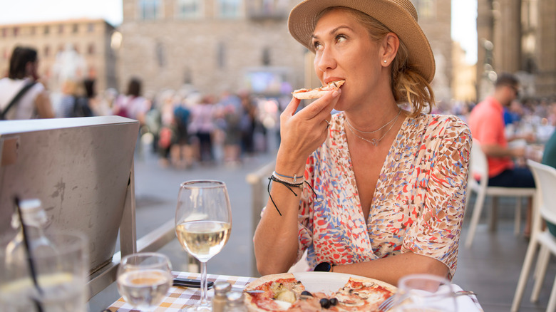 Traveler eating pizza in Italy