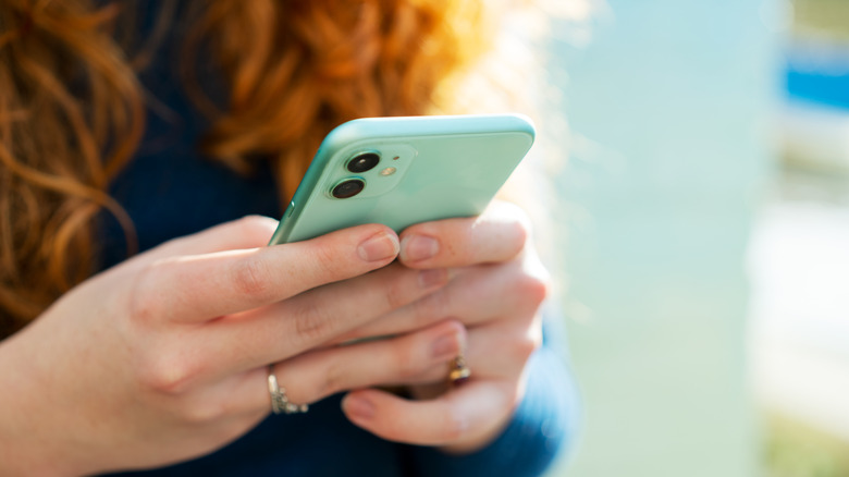 Close-up of hands holding cellphone