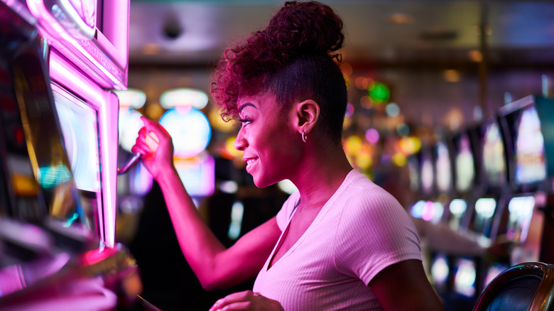 Woman playing slot machine