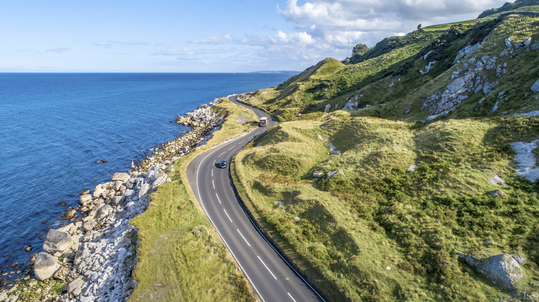 Vehicle driving on a coastal highway in Ireland