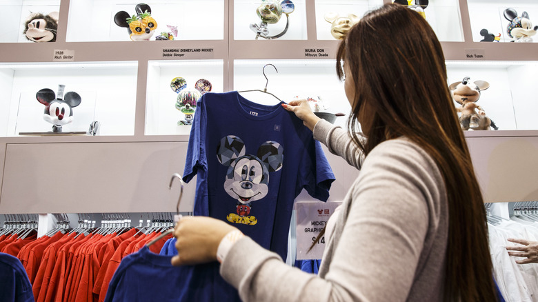 Woman shopping for Micky t-shirt