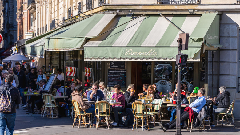 People at sidewalk cafe tables in Paris