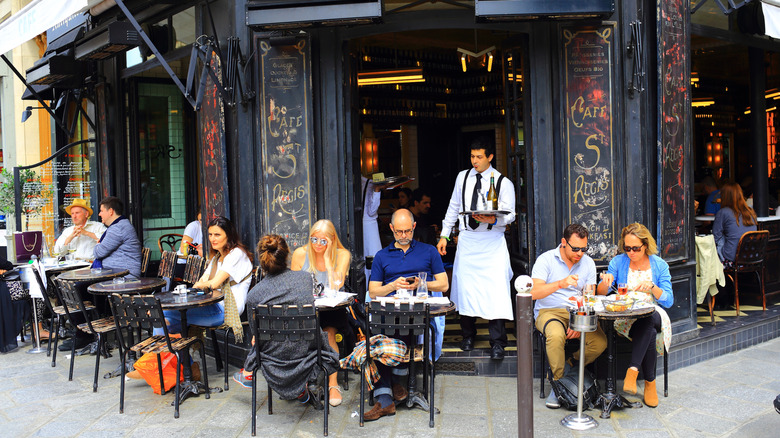 Waiter and restaurant patrons in France