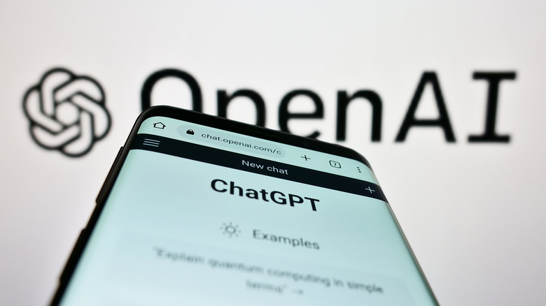 ChatGPT on a phone in front of a background reading 