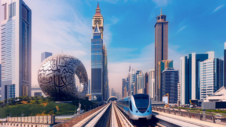 A metro train glides down tracks in Dubai