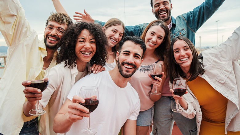 Group of young travelers posing with drinks