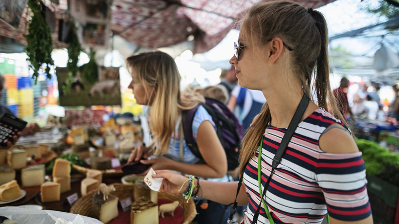 Travelers at a farmers market in Spain