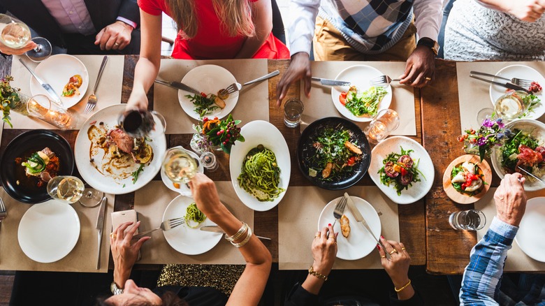 People gathered around a table eating