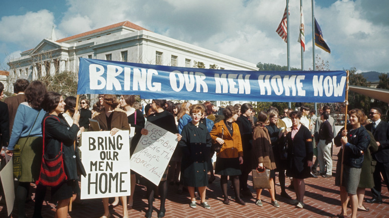 Vietnam war protestors holding a sign reading "Bring our men home"