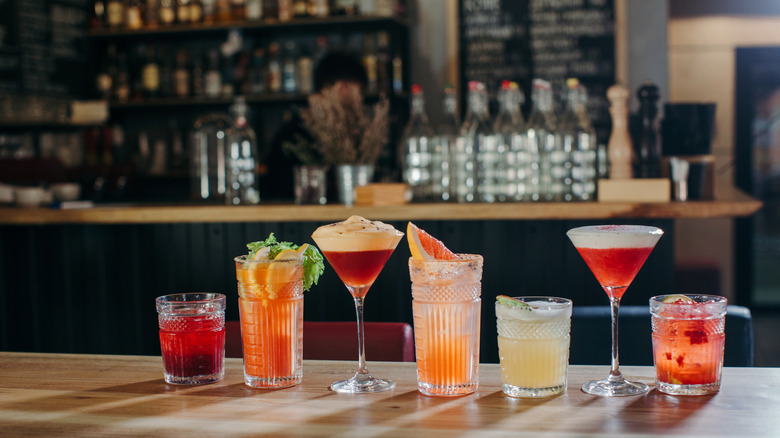 line up of a handful of freshly made creative cocktails