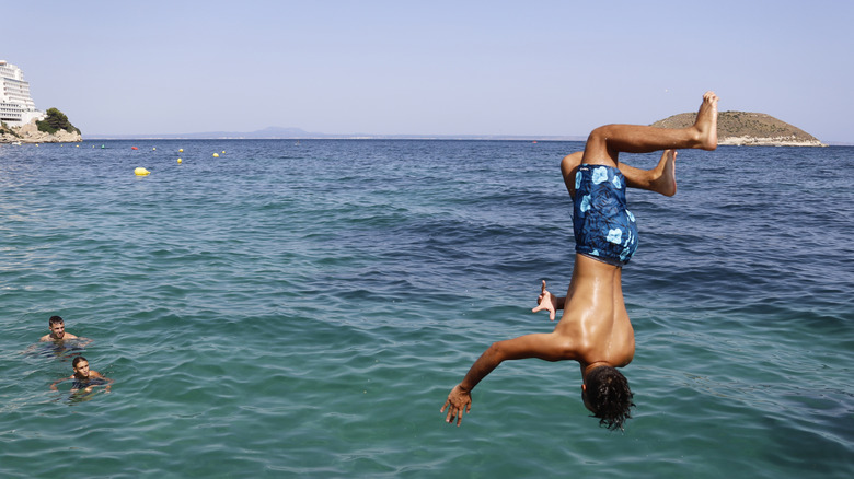 Boy jumping into sea in Magaluf