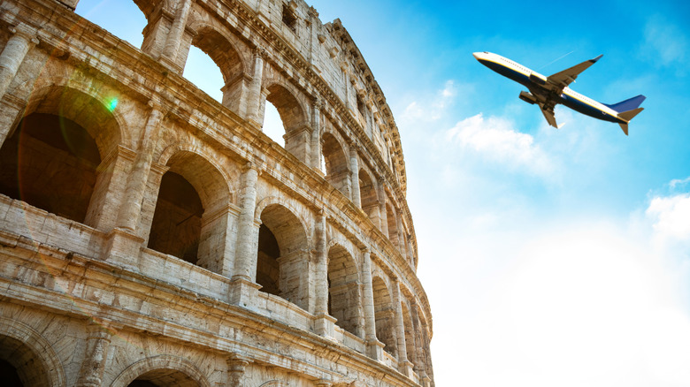 Plane flying over the Colosseum in Rome