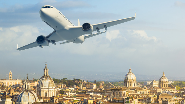 Plane flying low over old city in Italy