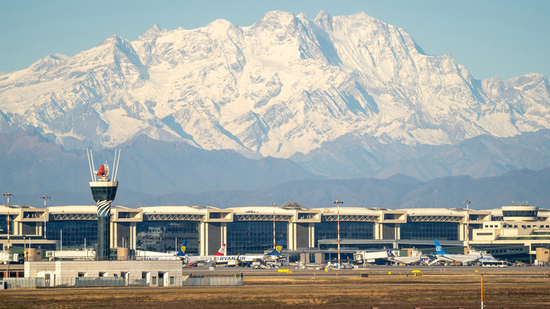 Milano Malpansa Airport with snow-capped mountains in the background