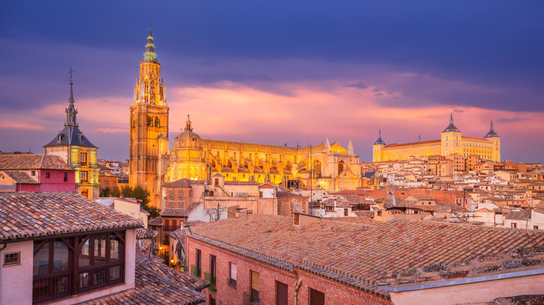 The Toledo Cathedral and Alcazar Fortress at twilight in Toledo, Spain