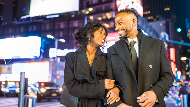 A well dressed couple poses in New York City.