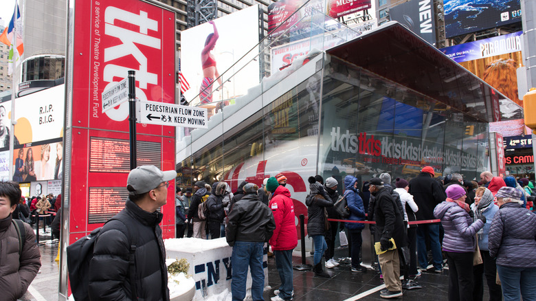 People wait in line at the TKTS kiosk in Times Square.