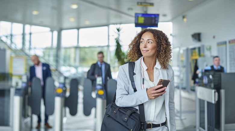 Airport traveler using their phone