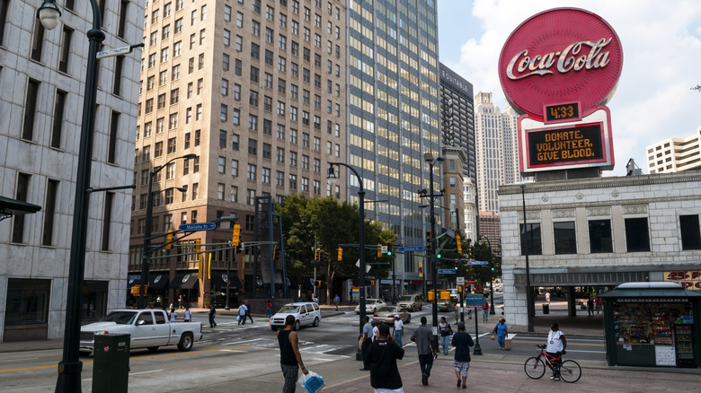 Coca-Cola sign in downtown Atlanta with buildings and pedestrians