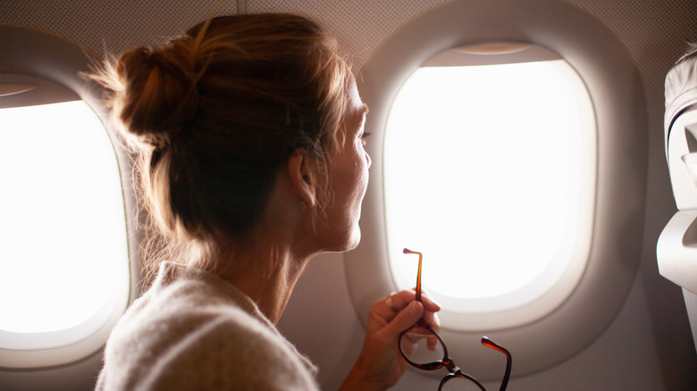 Woman with hair in bun on an airplane