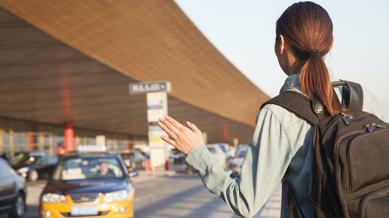 woman hailing cab in Beijing