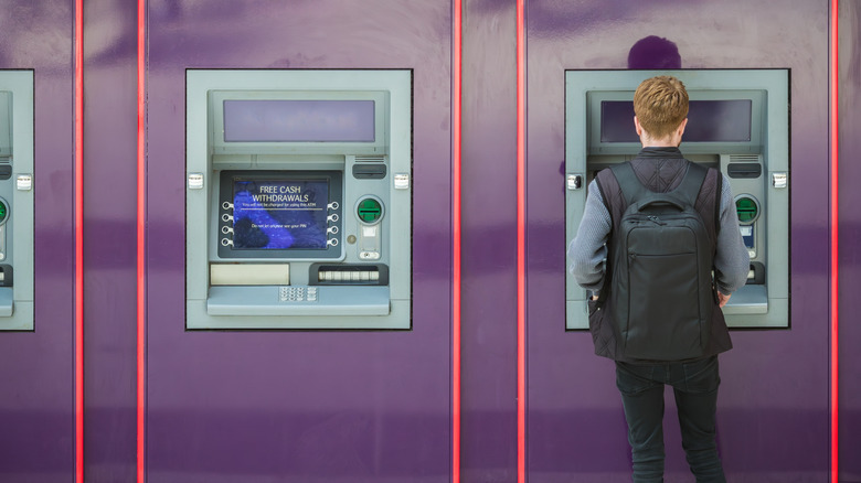 Man standing at an ATM