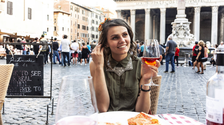 Traveler drinking a glass of wine