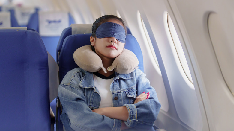 A woman sleeping on plane