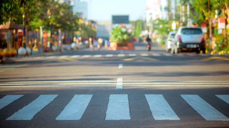 crosswalk with blurred city